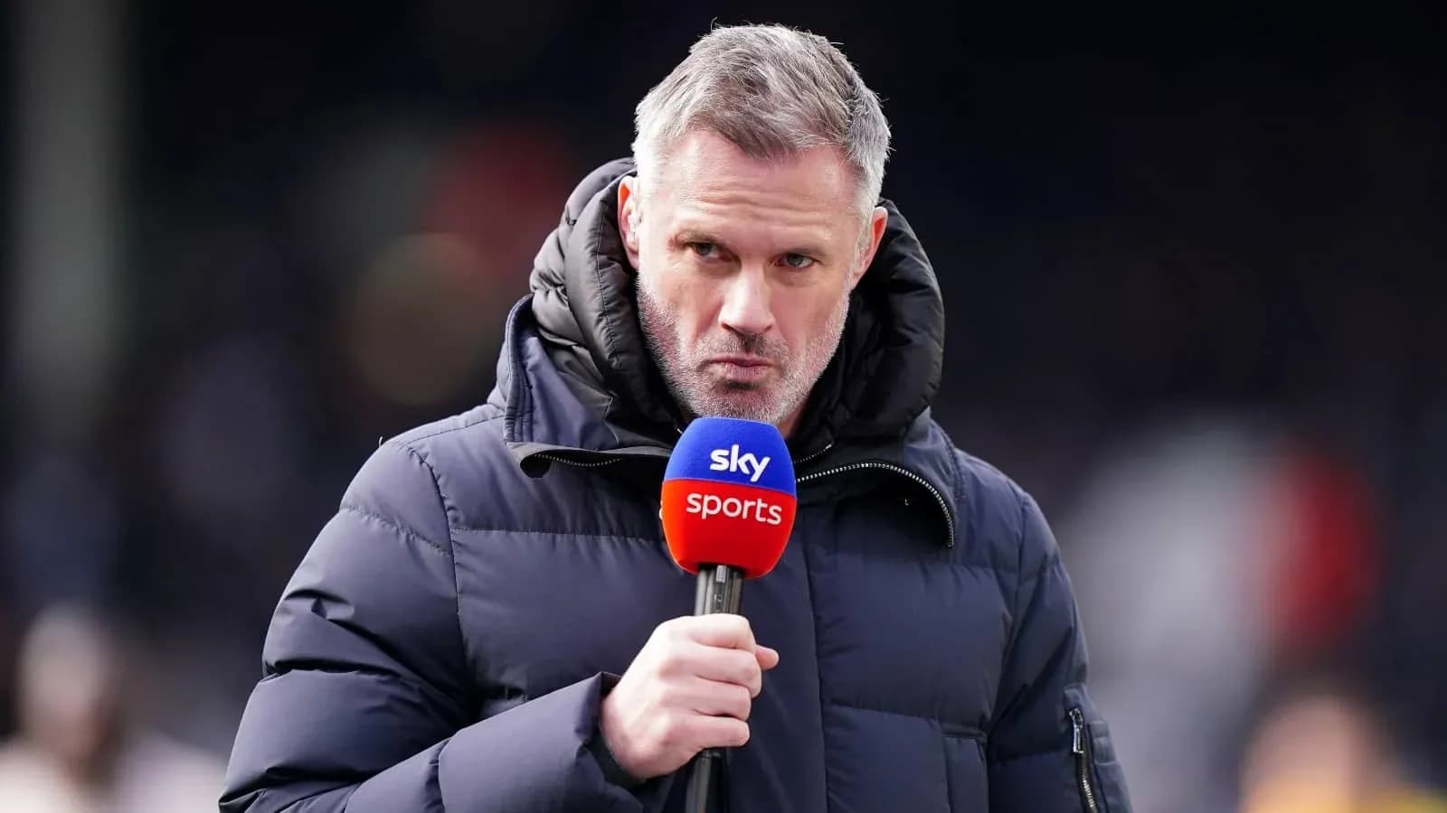 Sportscaster speaking into microphone on field Sportscaster speaking into microphone on field