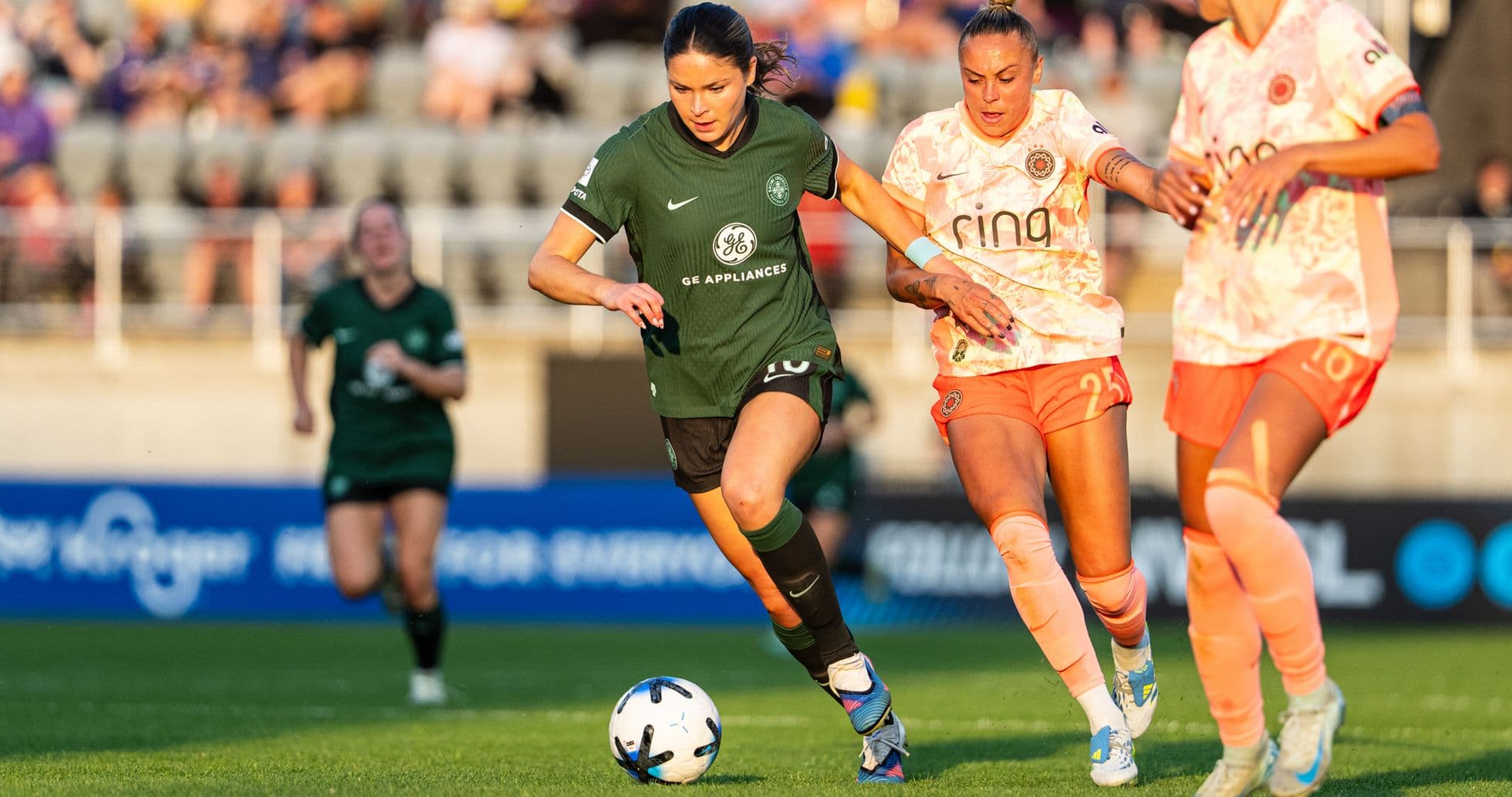 Player advancing with the ball in NWSL match Player advancing with the ball in NWSL match