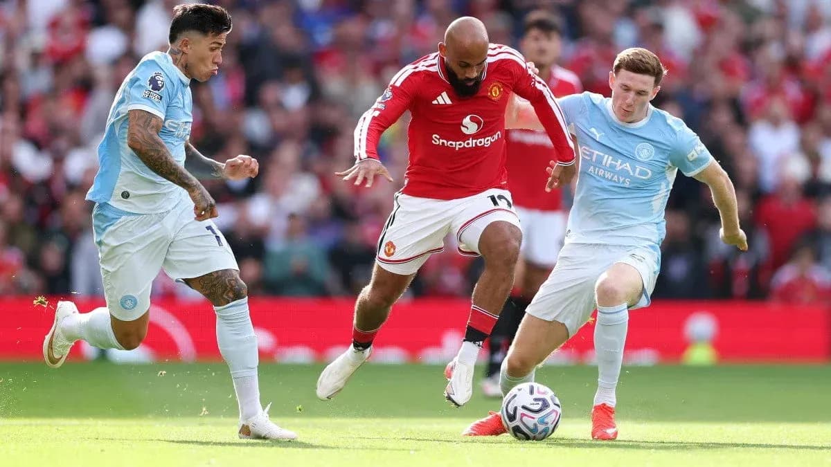 Manchester United and Manchester City players contesting for the ball Manchester United and Manchester City players contesting for the ball