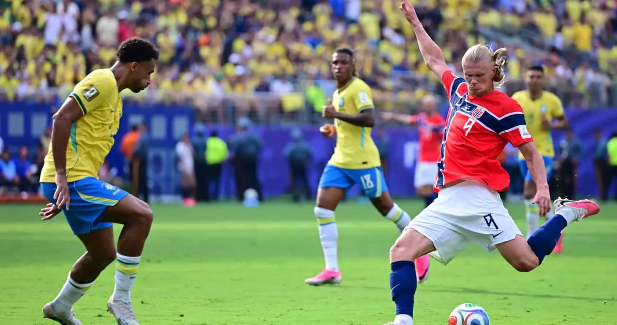 Brazil player defending against Norway striker Brazil player defending against Norway striker