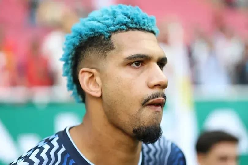 Player with blue hair preparing for match Player with blue hair preparing for match