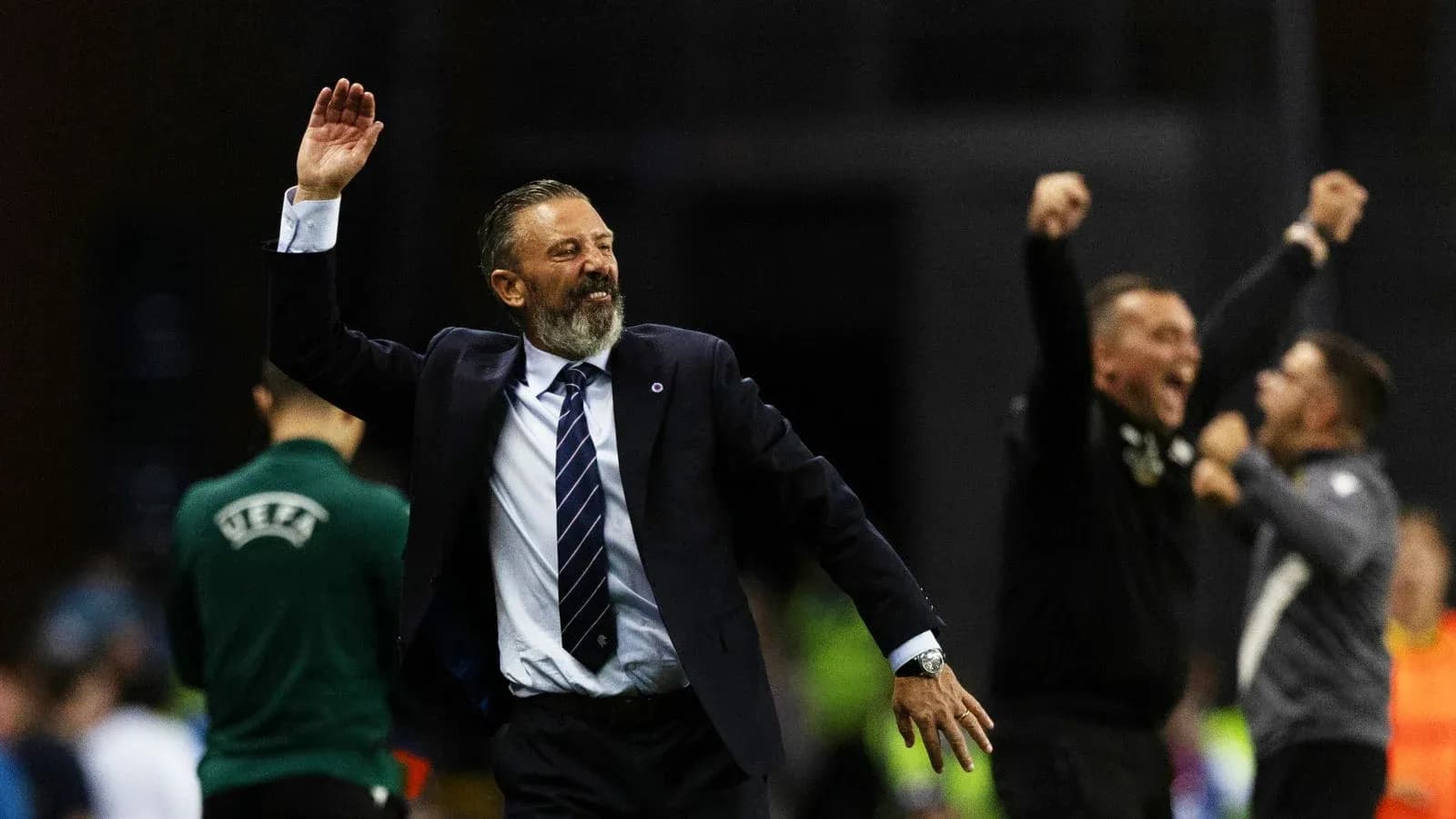 Coach celebrating with staff during match victory Coach celebrating with staff during match victory