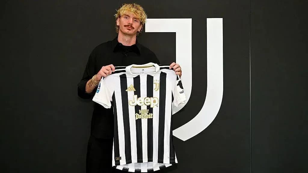 Player holding Juventus jersey at press conference Player holding Juventus jersey at press conference