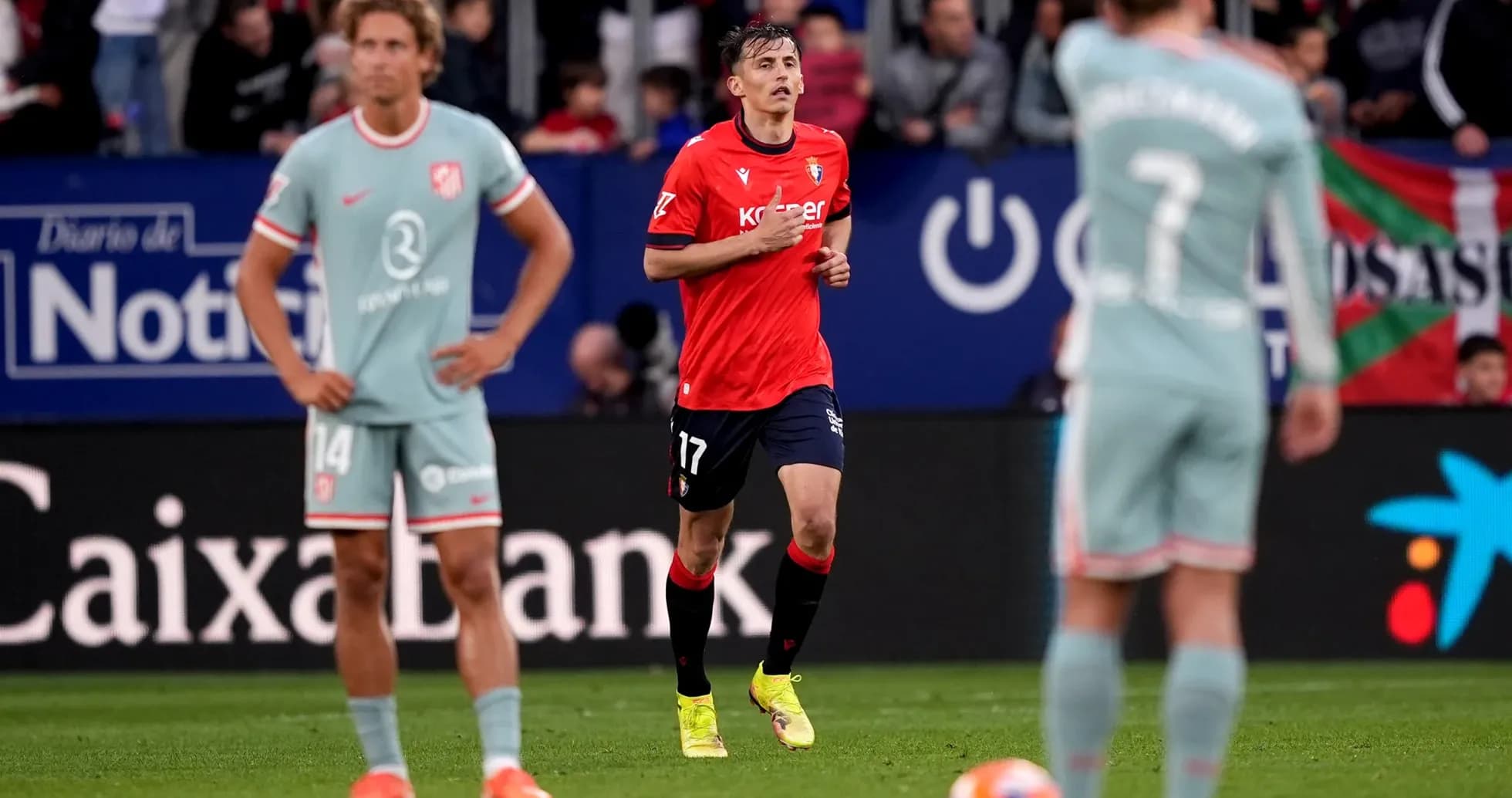 Osasuna player in action against Atletico Madrid Osasuna player in action against Atletico Madrid
