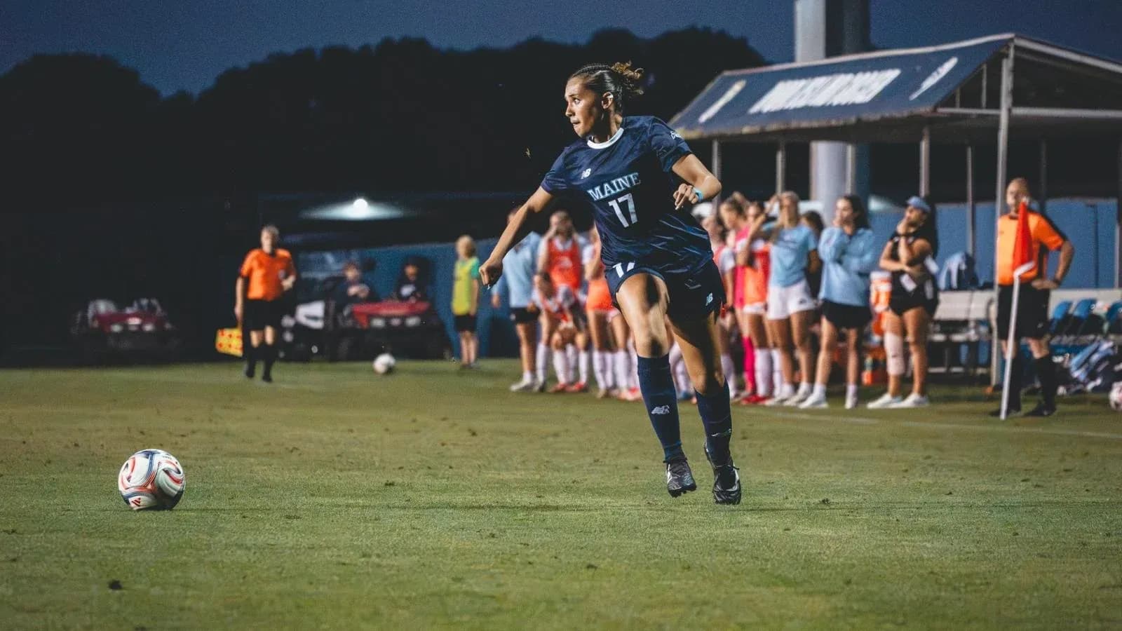 Player in blue jersey kicking soccer ball on field Player in blue jersey kicking soccer ball on field