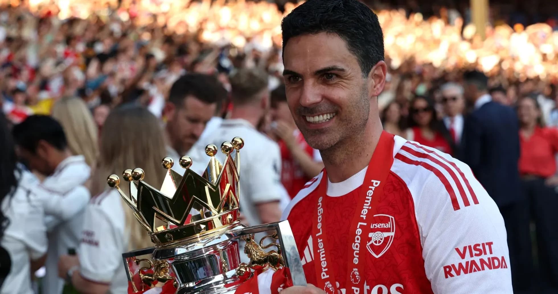 Manager holding Premier League trophy with fans celebrating Manager holding Premier League trophy with fans celebrating