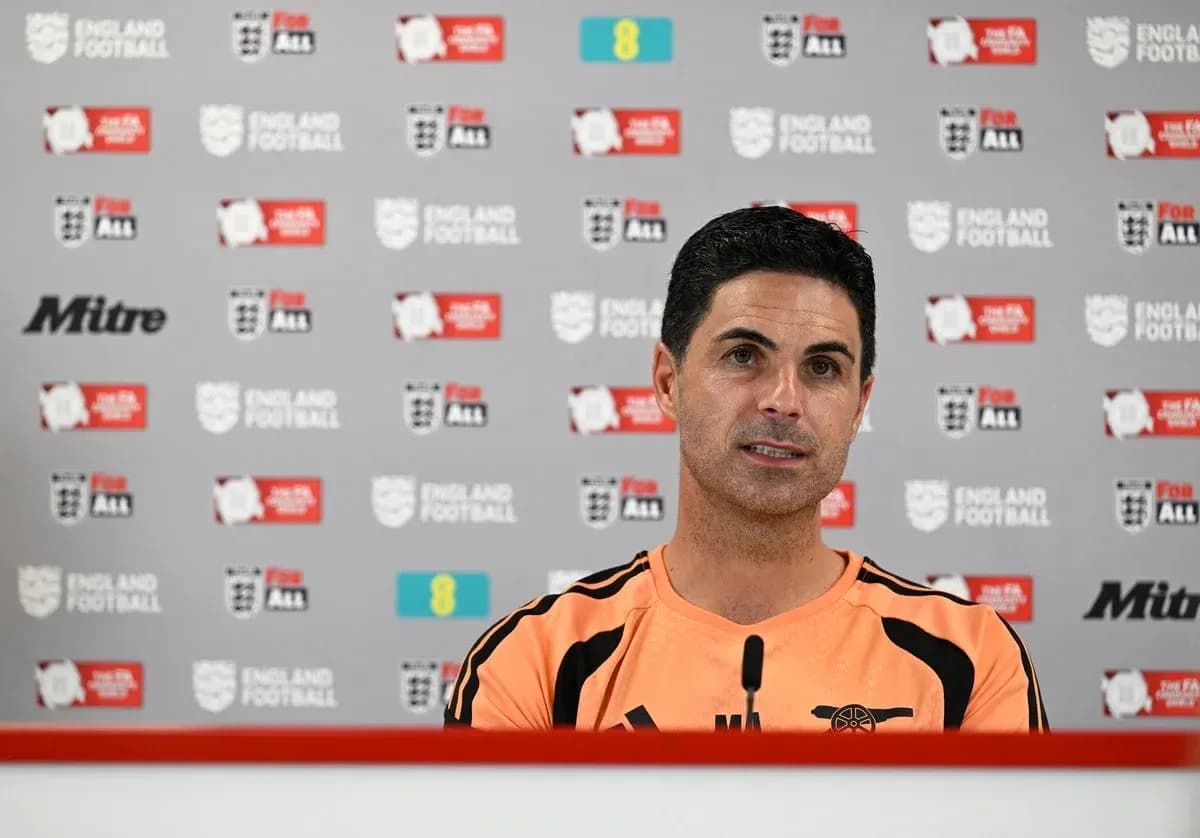 Coach speaking at press conference with backdrop Coach speaking at press conference with backdrop
