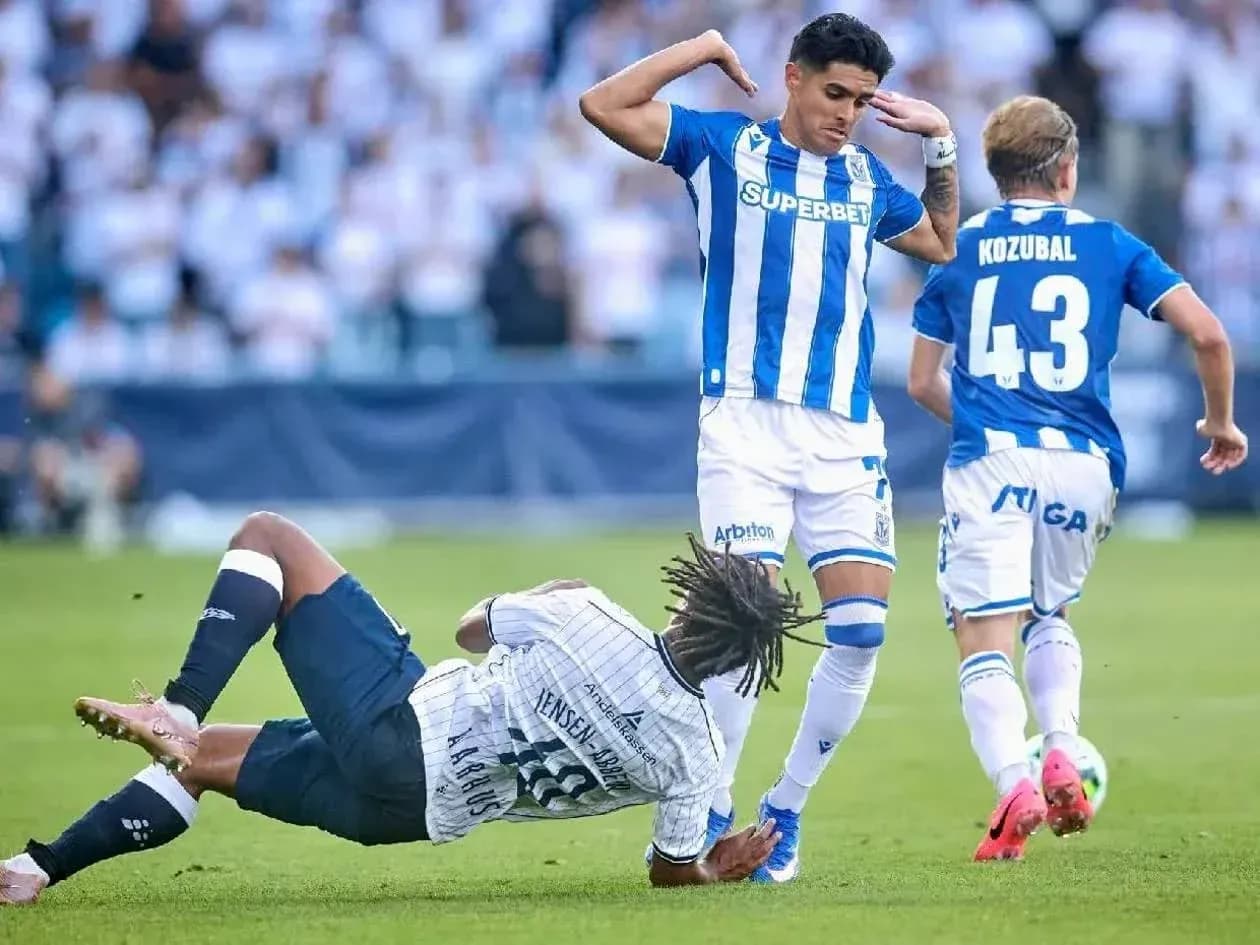 Lech Poznan player avoiding a tackle during match Lech Poznan player avoiding a tackle during match