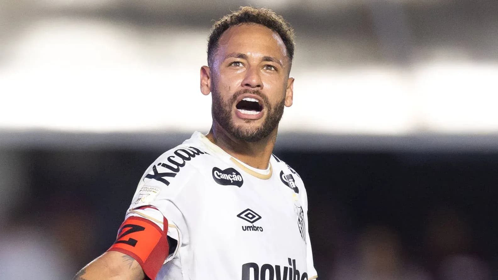 Player shouting on field wearing team jersey Player shouting on field wearing team jersey