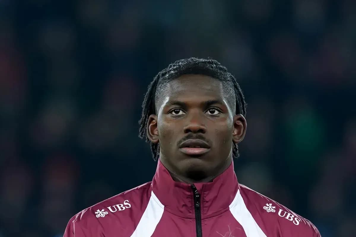 Player in maroon jacket looking ahead during match Player in maroon jacket looking ahead during match