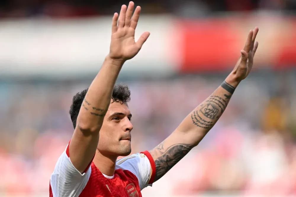 Player waving to fans after match conclusion Player waving to fans after match conclusion