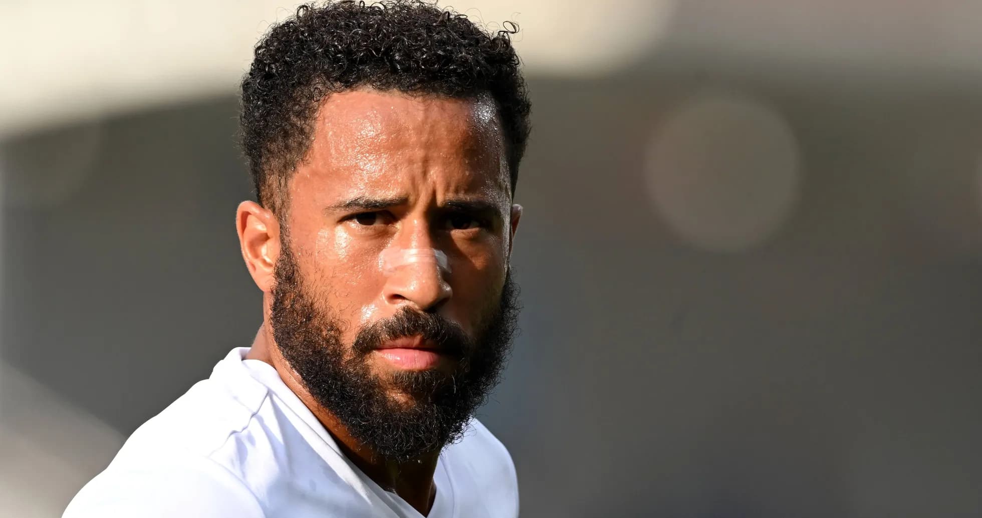 Player with beard and bandage on nose looking forward Player with beard and bandage on nose looking forward