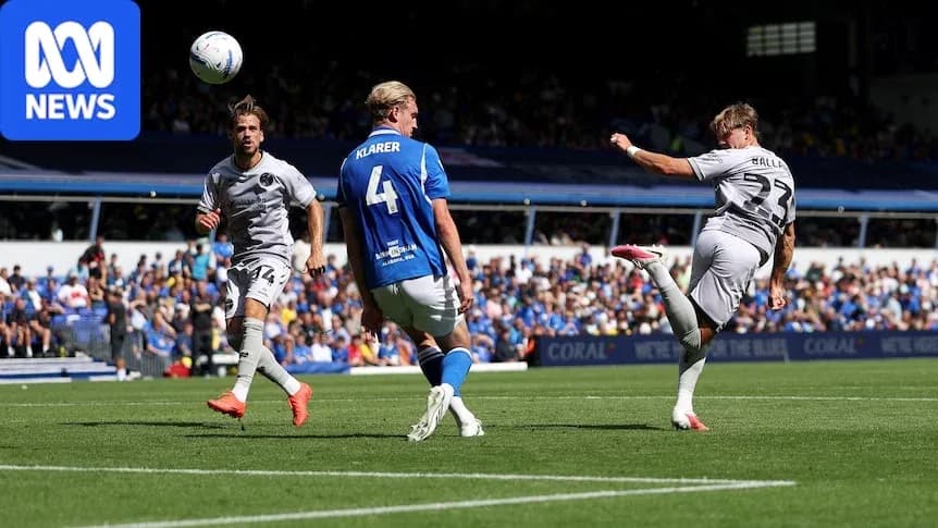Player striking the ball during a football match Player striking the ball during a football match