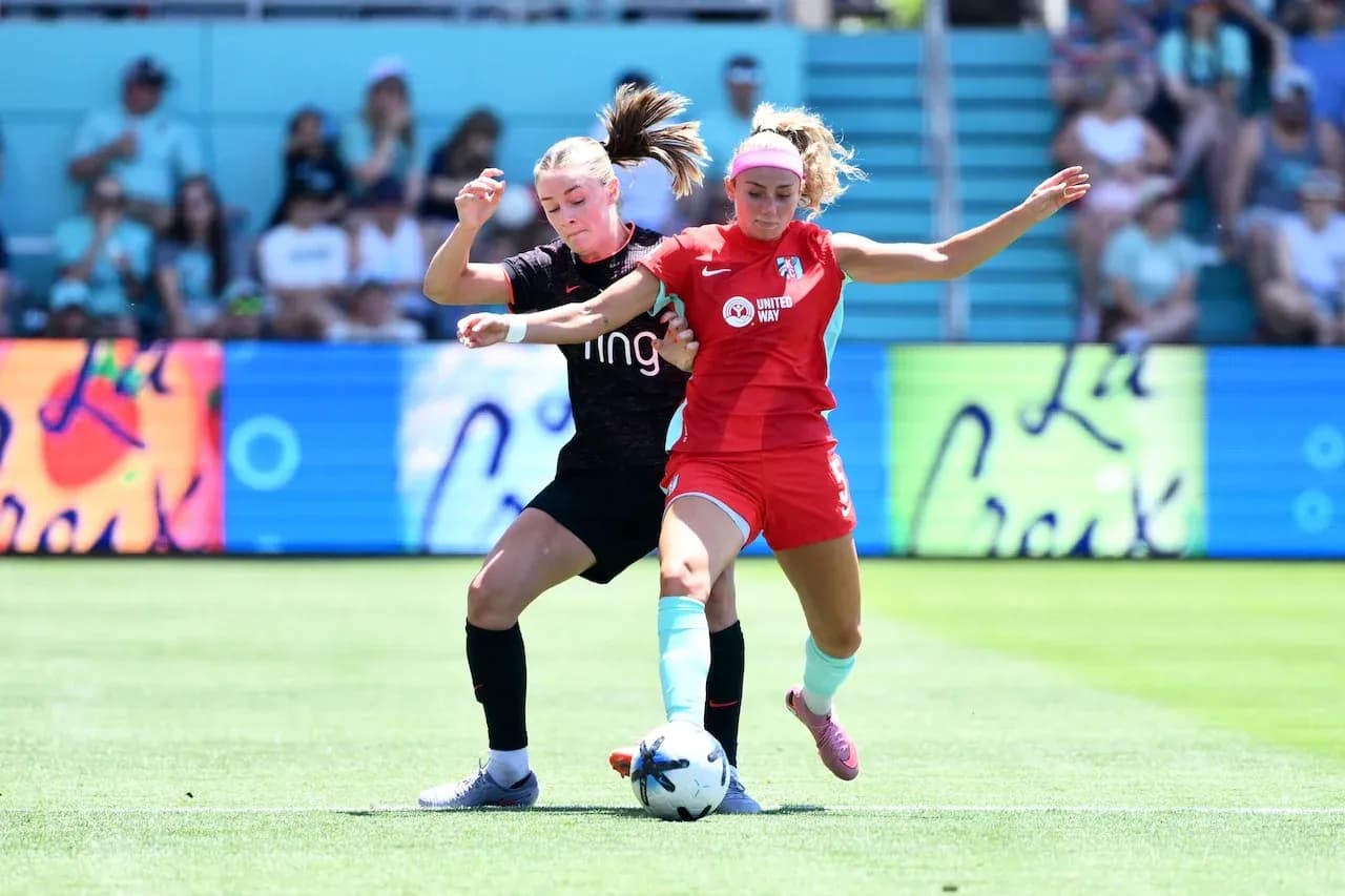Two players competing for the ball in match Two players competing for the ball in match
