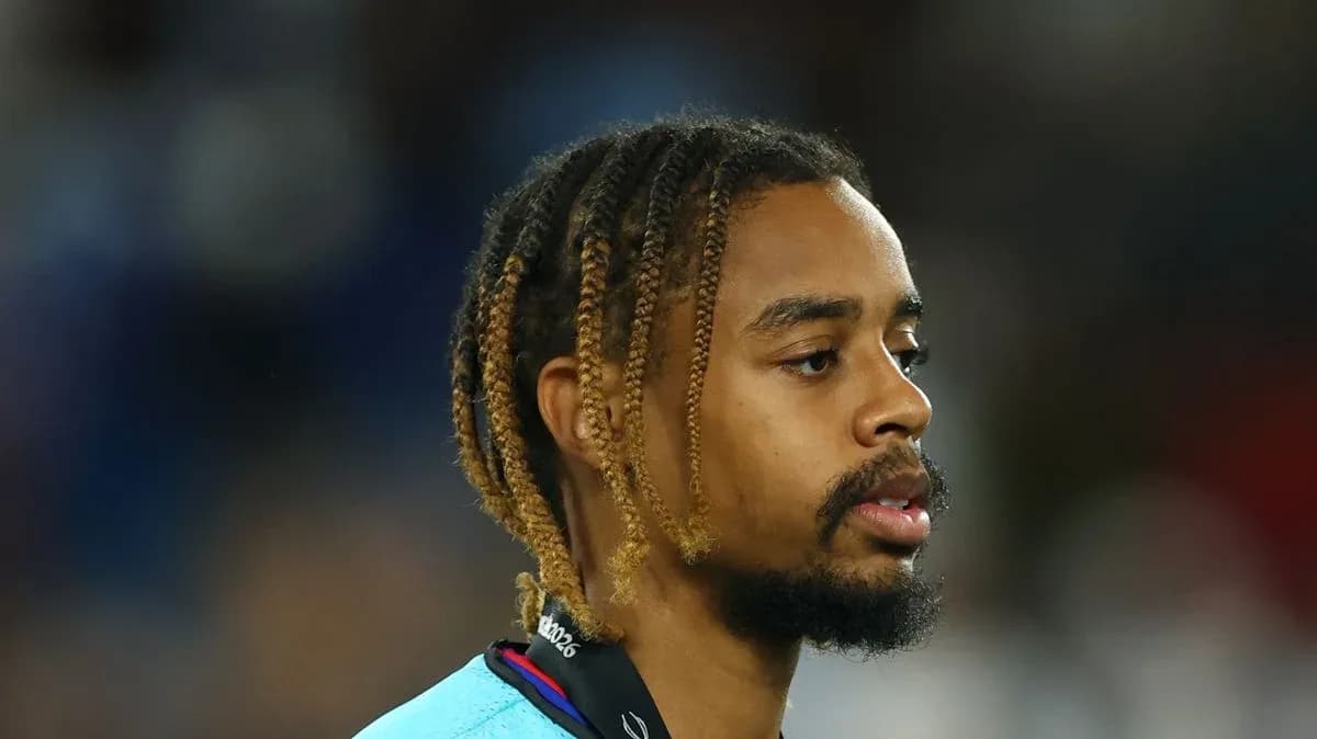 Player with braided hair on the sidelines Player with braided hair on the sidelines