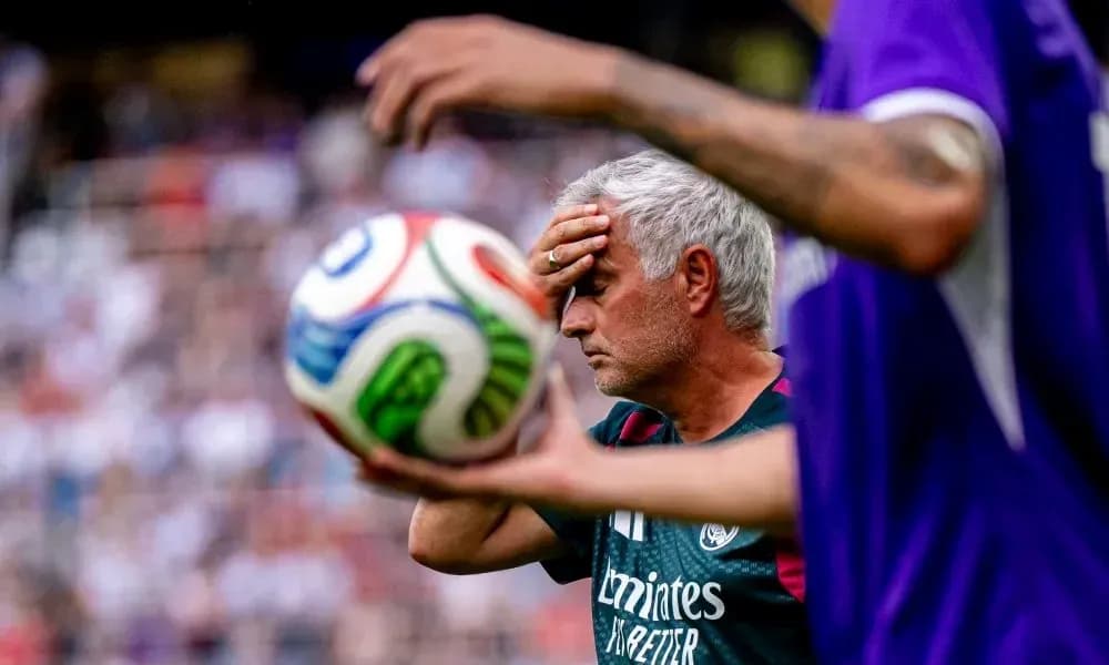 Manager holding forehead during match with ball Manager holding forehead during match with ball