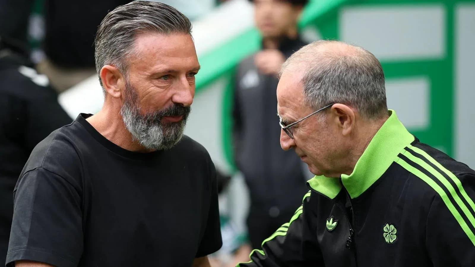 Two coaches interacting on the sidelines before a match Two coaches interacting on the sidelines before a match