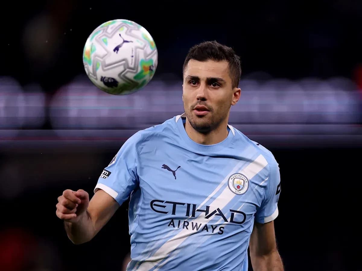 Player in Manchester City kit controlling a ball Player in Manchester City kit controlling a ball