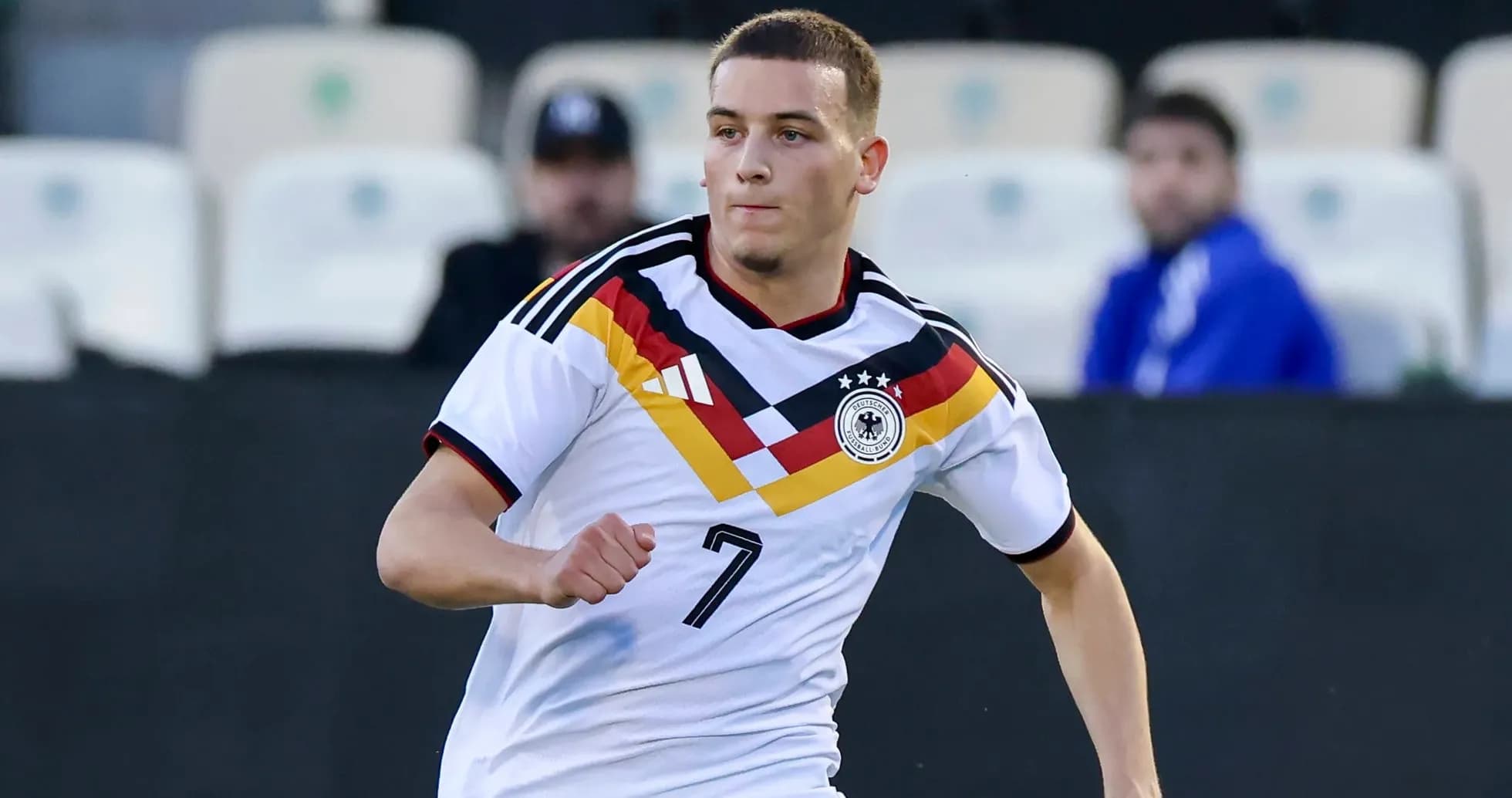 Player wearing Germany jersey running on the field Player wearing Germany jersey running on the field