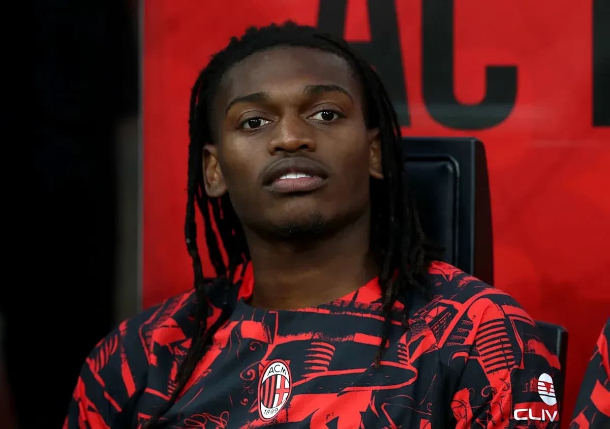 Player seated on bench wearing AC Milan kit Player seated on bench wearing AC Milan kit