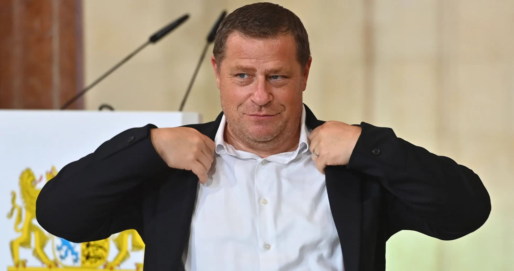 Man adjusting his jacket during press conference Man adjusting his jacket during press conference
