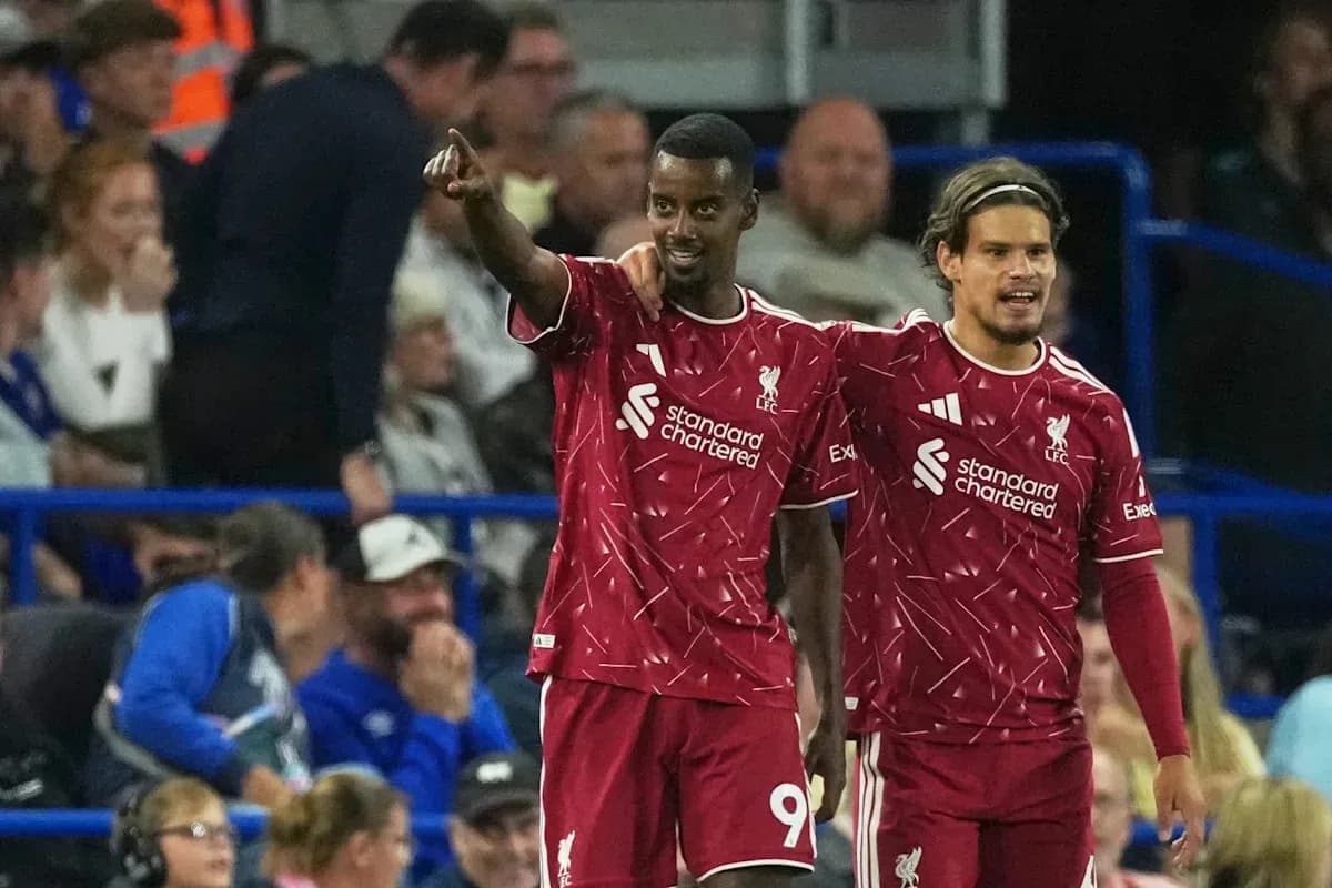Two Liverpool players celebrating a goal together Two Liverpool players celebrating a goal together