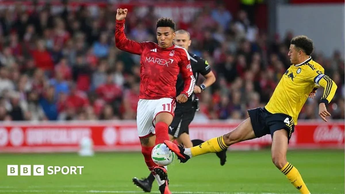 Player in red tackling opponent in yellow during match Player in red tackling opponent in yellow during match