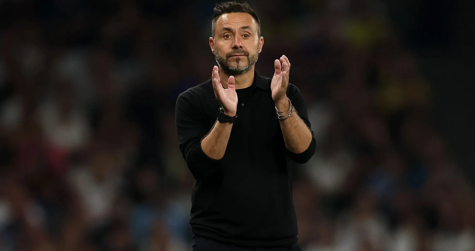 Coach applauding during a football match Coach applauding during a football match