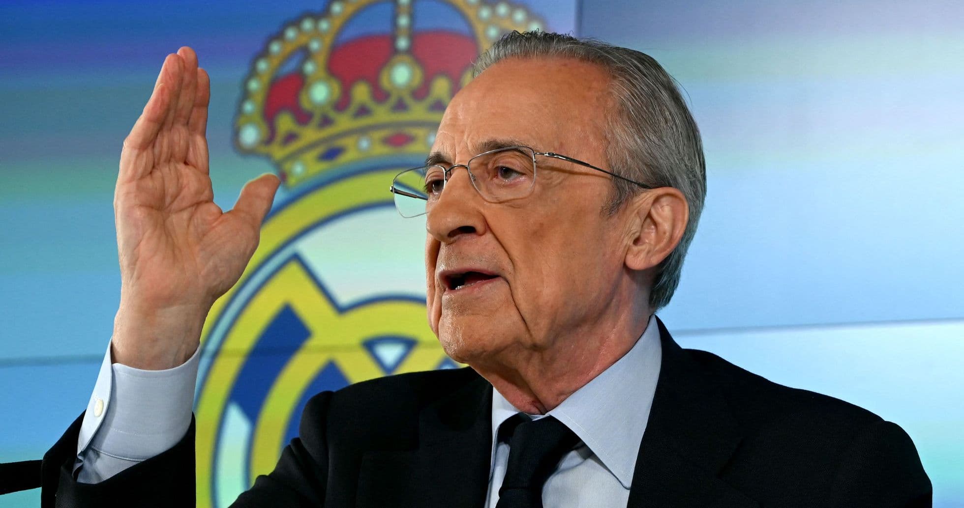 Official speaking at press conference with Real Madrid logo Official speaking at press conference with Real Madrid logo