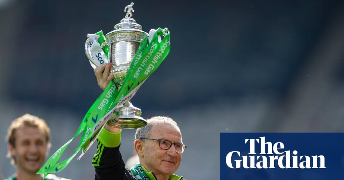 Person holding trophy with green ribbons aloft Person holding trophy with green ribbons aloft