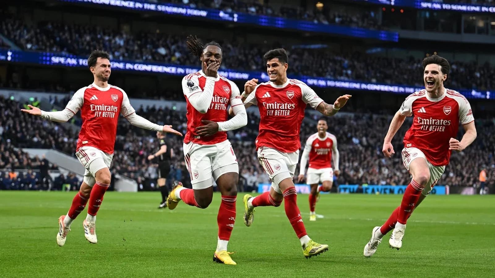 Arsenal players celebrating a goal on the pitch Arsenal players celebrating a goal on the pitch