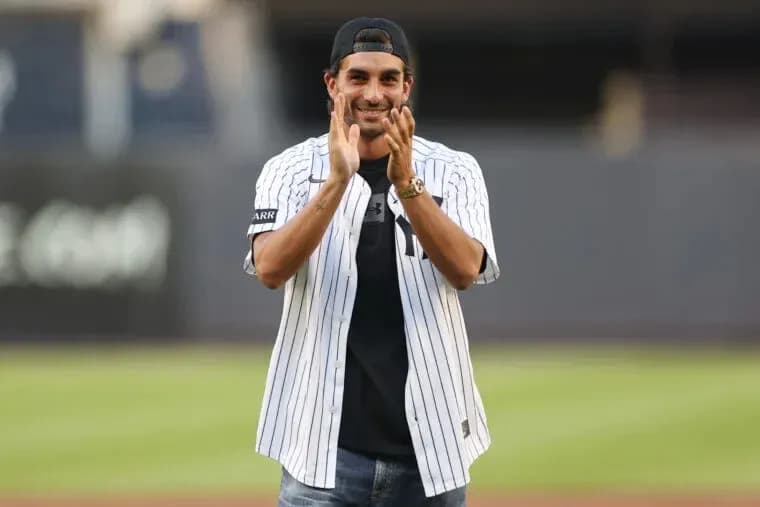 Man in Yankees jersey applauding at stadium Man in Yankees jersey applauding at stadium