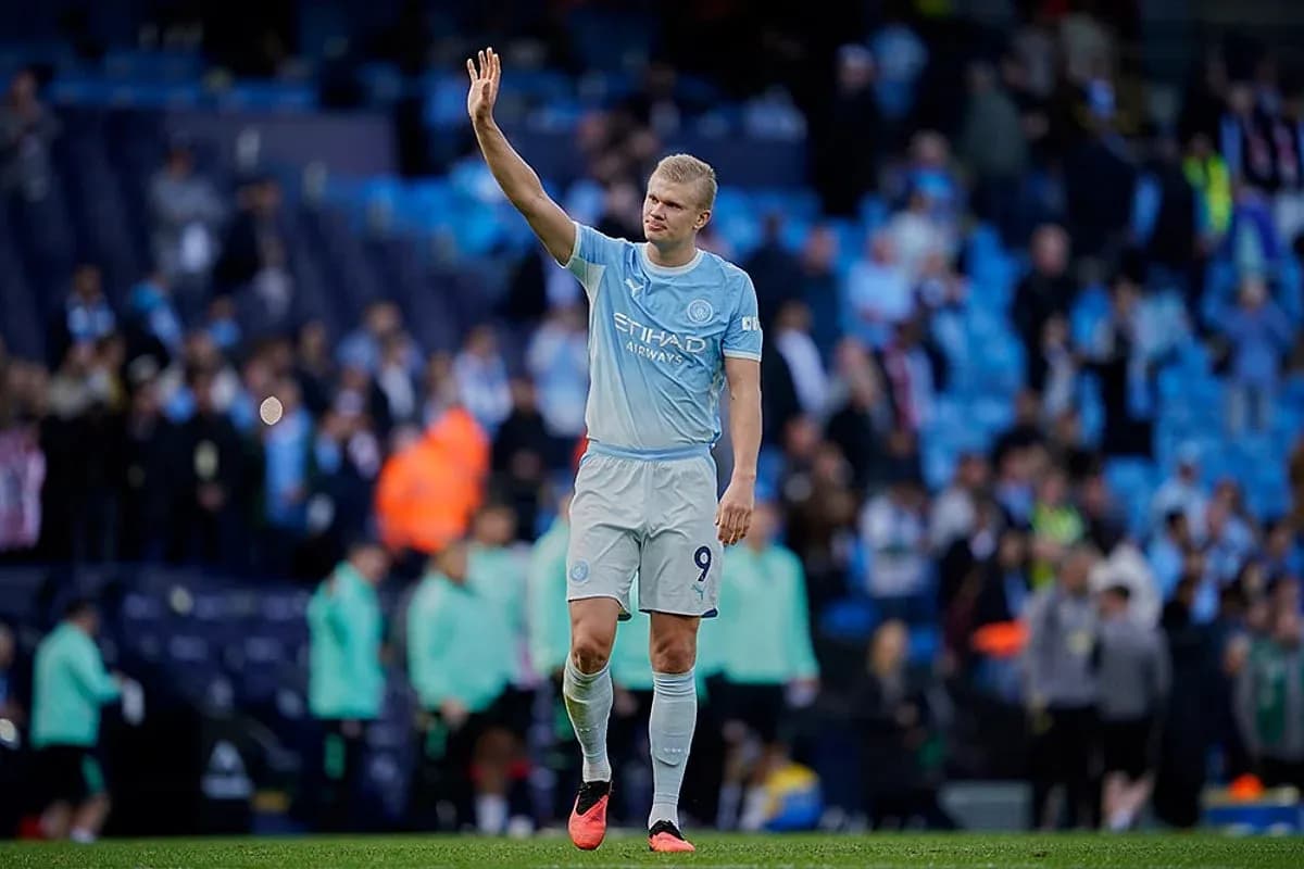 Player waving to fans at Manchester City match Player waving to fans at Manchester City match