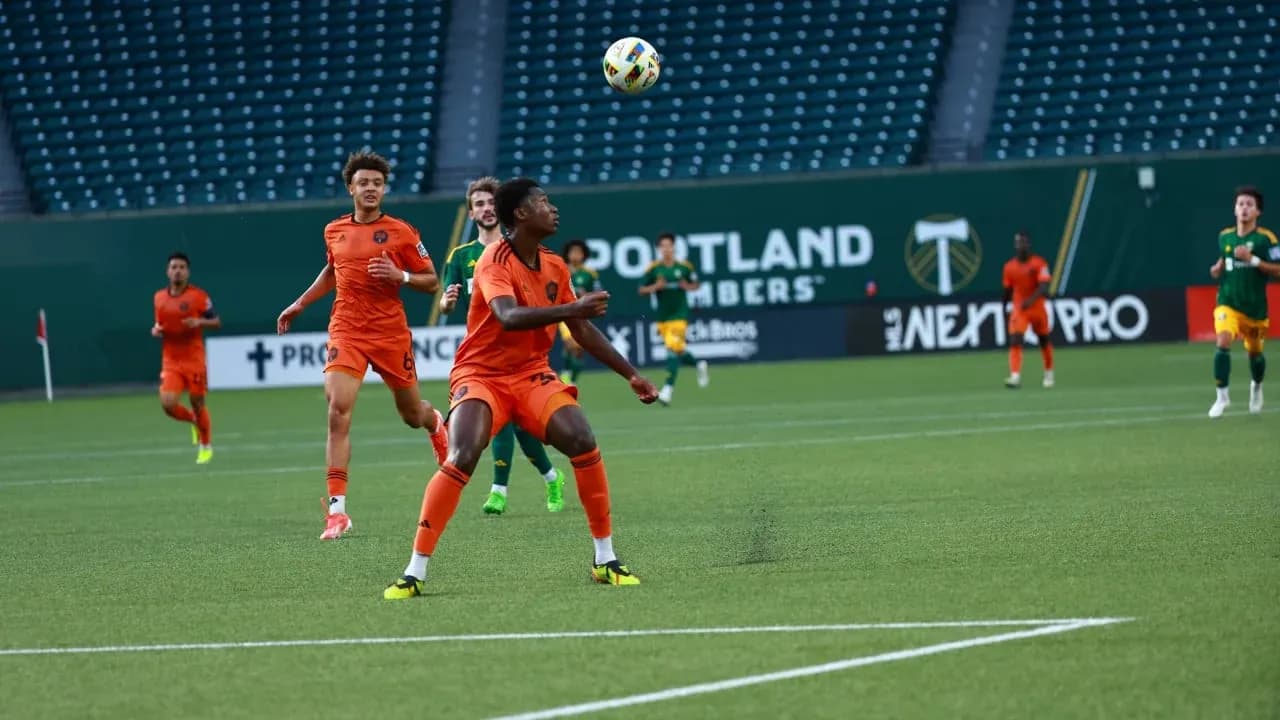 Players competing for the ball in MLS Next Pro match Players competing for the ball in MLS Next Pro match