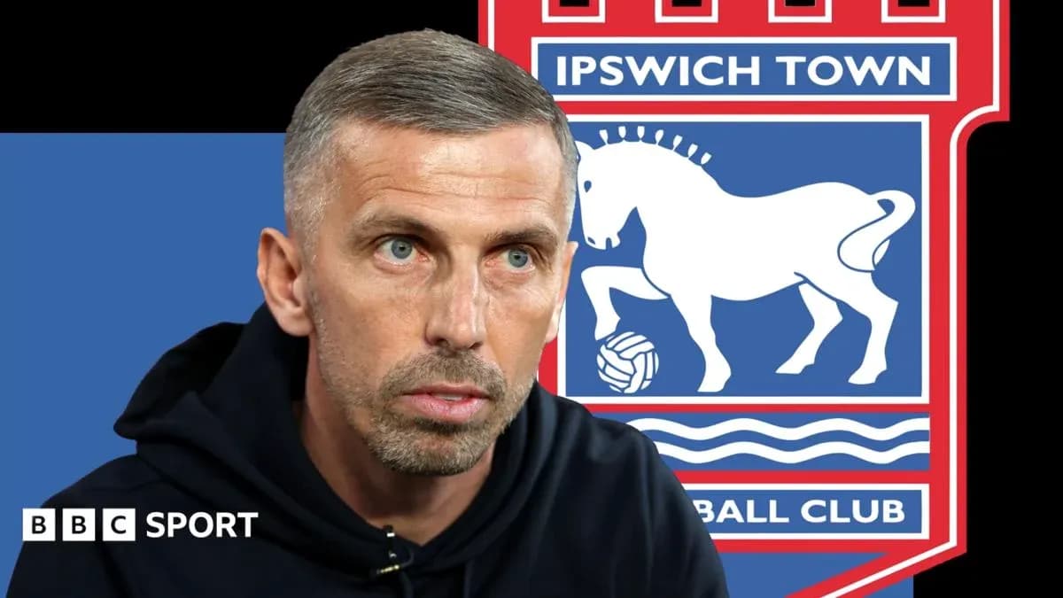 Coach speaking with Ipswich Town logo in background Coach speaking with Ipswich Town logo in background