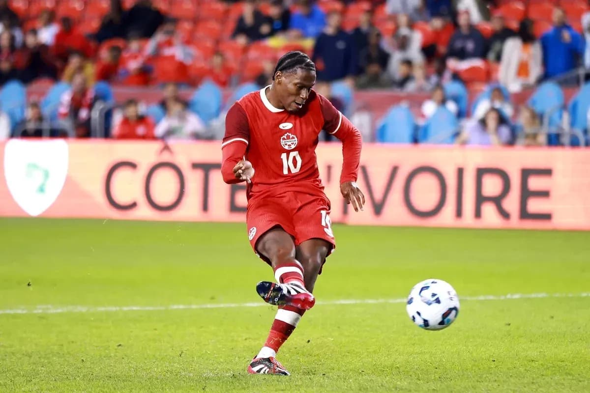 Player kicking ball during soccer match in stadium Player kicking ball during soccer match in stadium