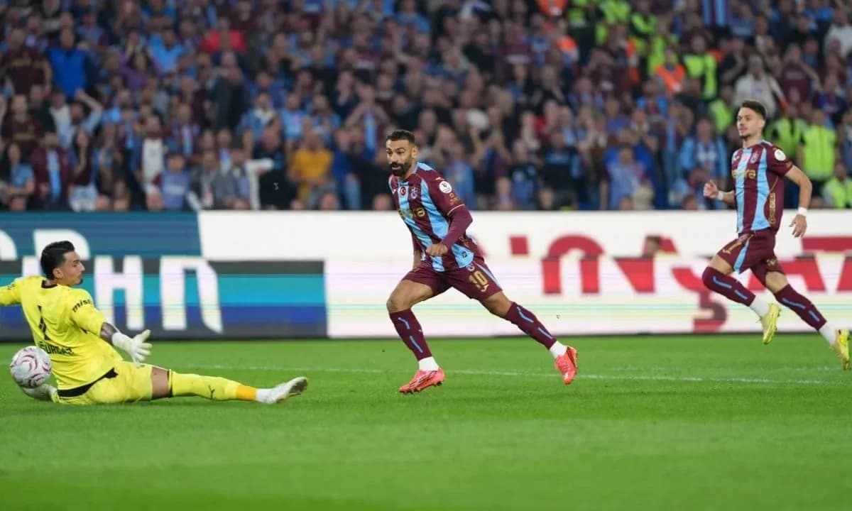 Player scoring while goalkeeper attempts to block shot Player scoring while goalkeeper attempts to block shot
