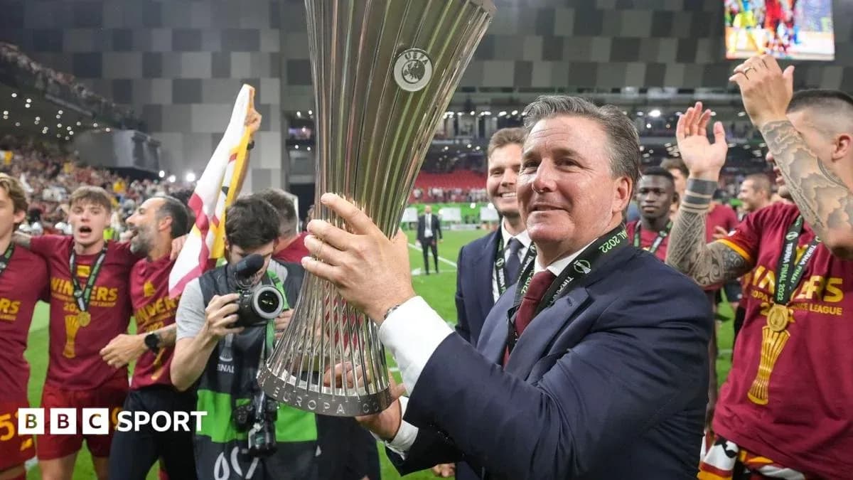 Coach celebrating with Europa League trophy and players Coach celebrating with Europa League trophy and players