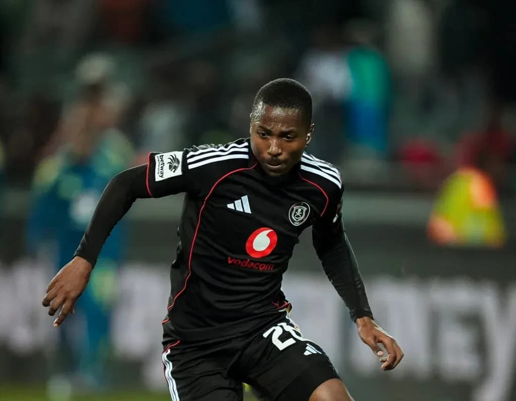 Player in black jersey running during a match Player in black jersey running during a match