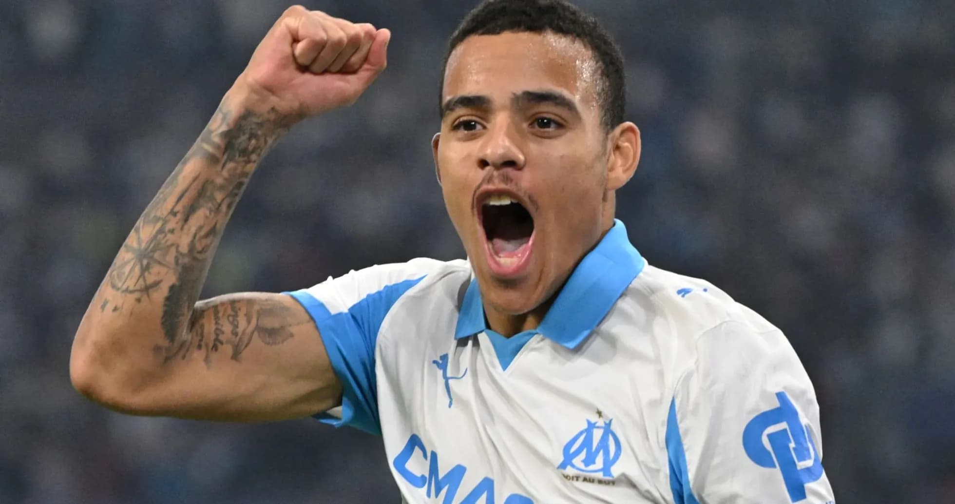 Player celebrating with raised fist in Marseille jersey Player celebrating with raised fist in Marseille jersey