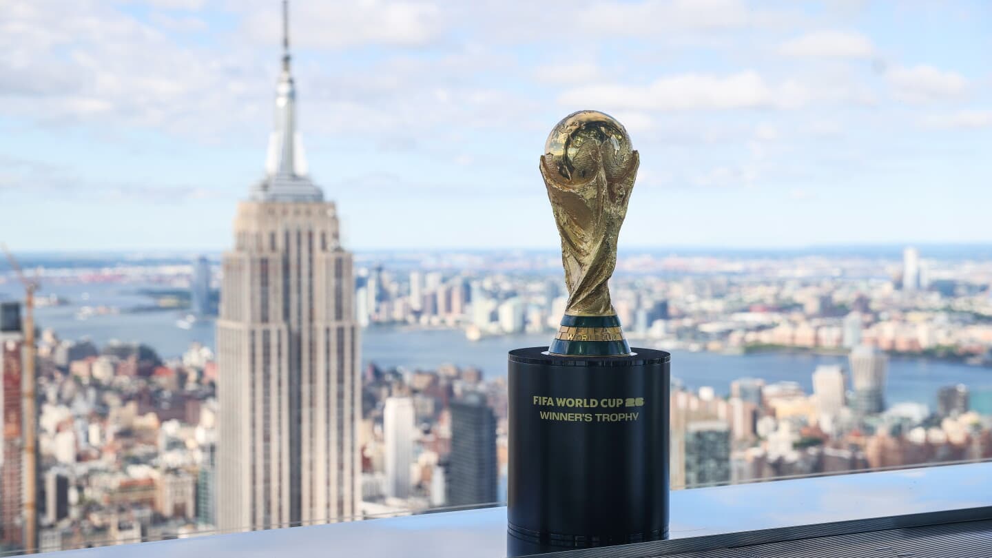 FIFA World Cup trophy with city skyline backdrop FIFA World Cup trophy with city skyline backdrop