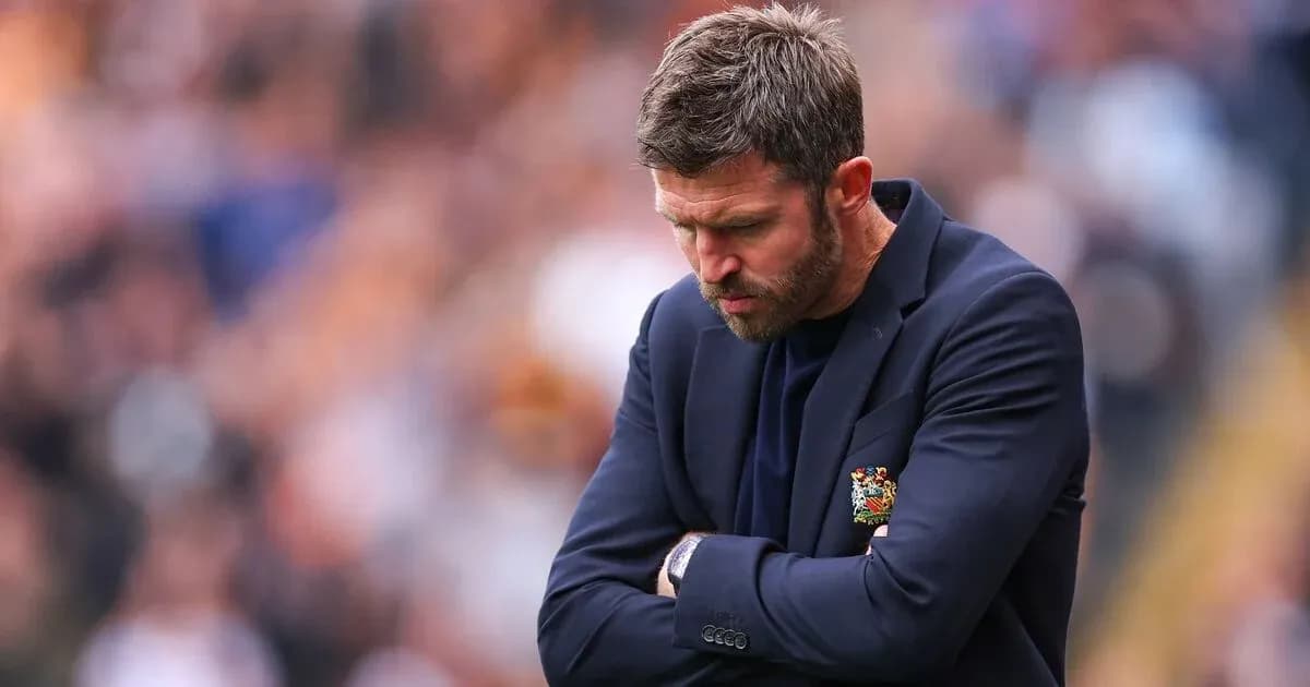 Coach looking down with arms crossed during match Coach looking down with arms crossed during match