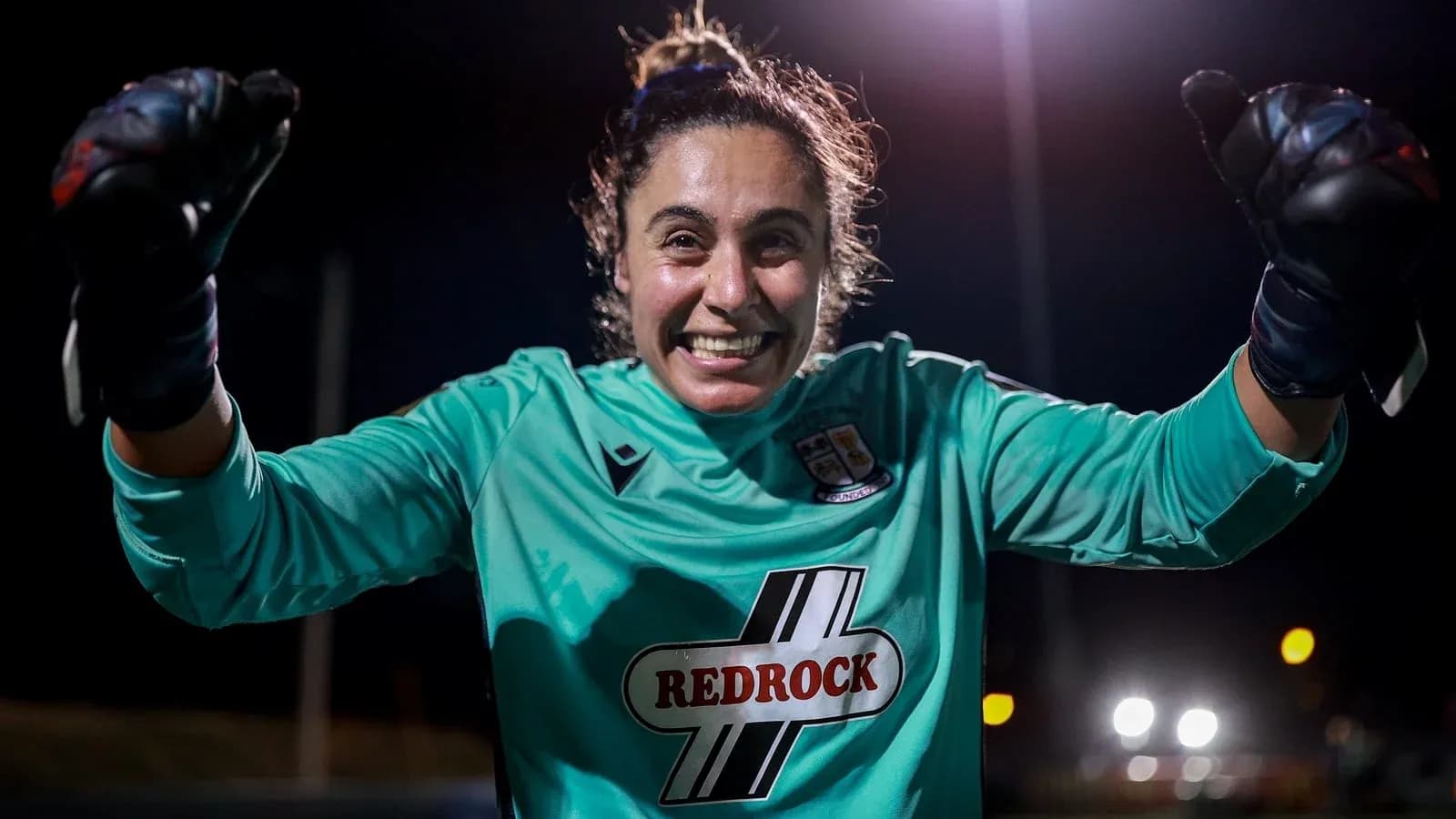 Goalkeeper celebrating with clenched fists at night Goalkeeper celebrating with clenched fists at night