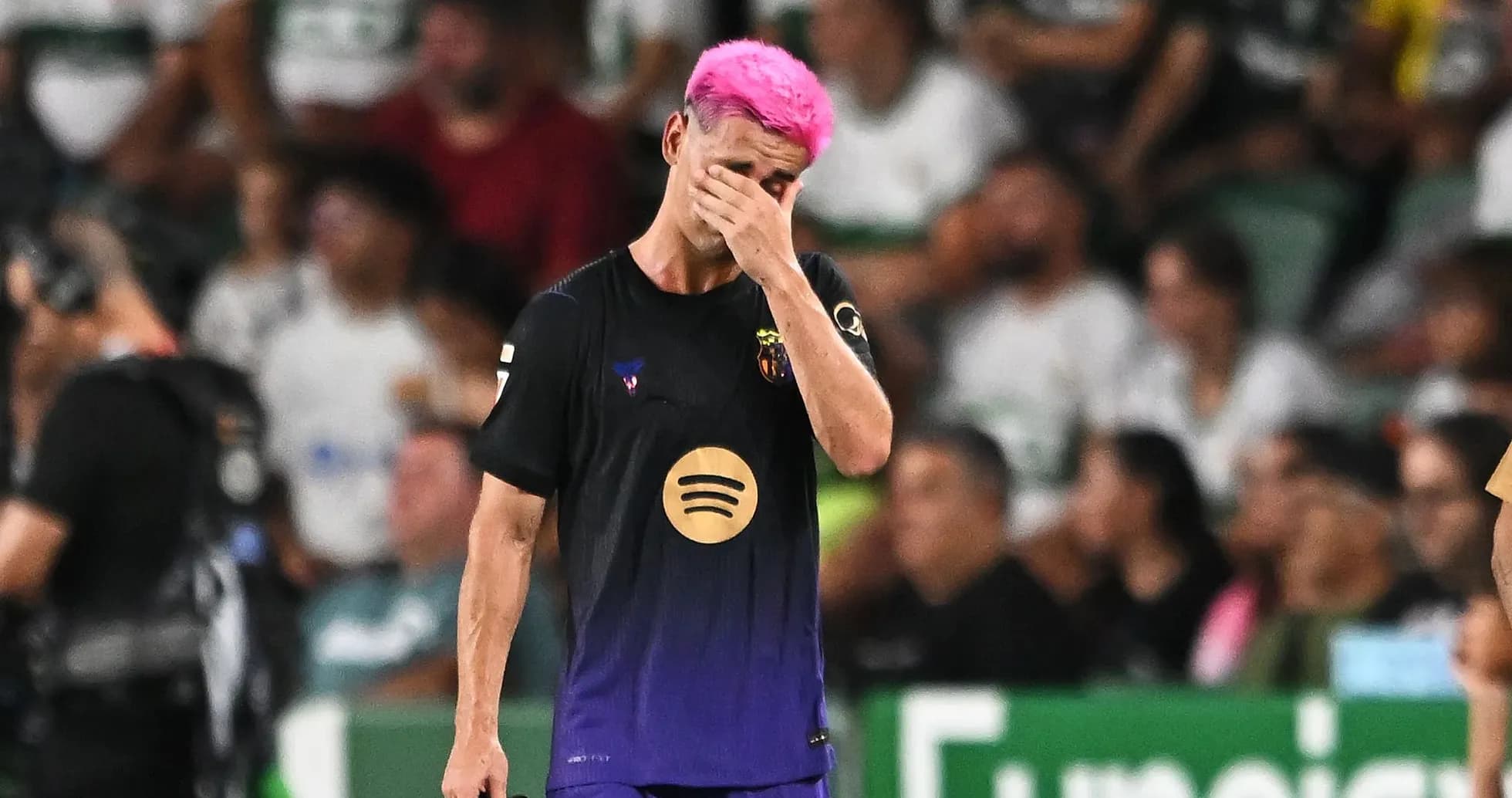 Player with pink hair walking off field in distress Player with pink hair walking off field in distress
