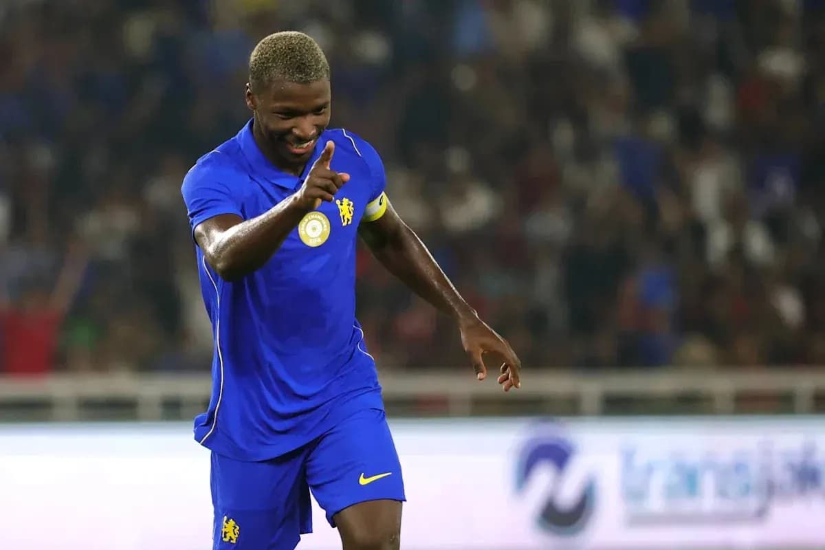Player celebrating goal with finger raised in stadium Player celebrating goal with finger raised in stadium
