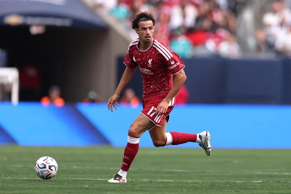 Player in red Liverpool kit dribbling the ball Player in red Liverpool kit dribbling the ball