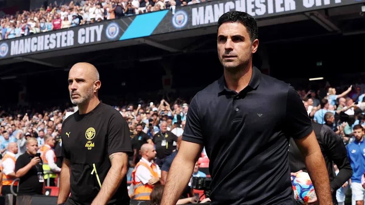 Two coaches walking onto the pitch at stadium Two coaches walking onto the pitch at stadium