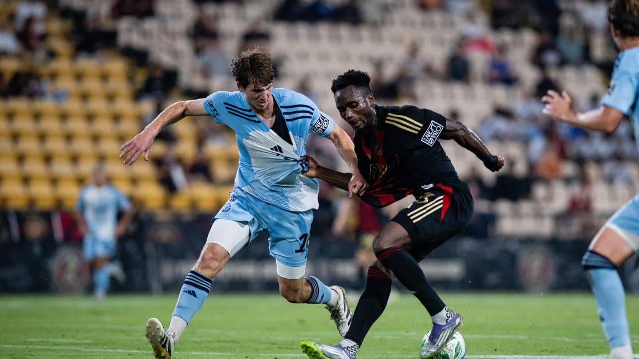 Atlanta United II player tackling Chattanooga opponent Atlanta United II player tackling Chattanooga opponent
