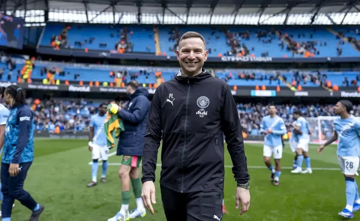 Coach smiling on the pitch after the match Coach smiling on the pitch after the match