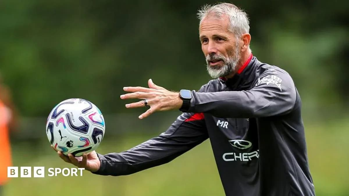 Coach demonstrating a drill while holding a ball Coach demonstrating a drill while holding a ball